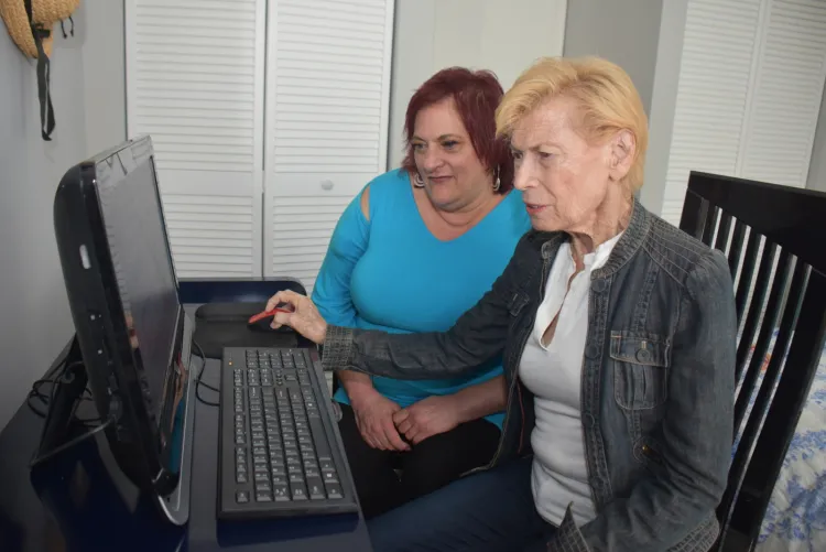 Stacy helping a customer with her computer