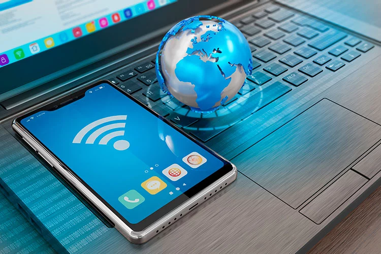 Internet connection symbols - computer, smartphone and globe model on laptop keyboard - 3D illustration