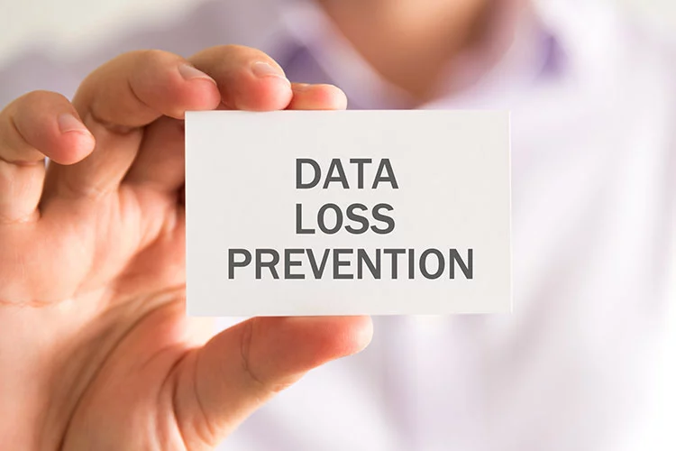 Closeup on businessman holding a card with DLP Data Loss Prevention message, business concept image with soft focus background